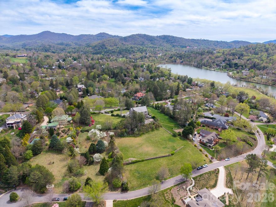 Exceptional building opportunity in a prime North Asheville location with wonderful long and short range mountain views. This rare homesite in The Midlands offers the perfect blend of convenience, setting, and mountain views—without the challenge of a steep drive.  The cleared, gently positioned .69 acre lot is ideal for construction, making it ready for your vision. Enjoy unobstructed mountain views and a beautiful natural backdrop that creates an inviting setting for a custom home. Located just steps from Beaver Lake and its scenic walking trail, the Asheville Country Club, the Public Library, and Fresh Market, this property also provides quick access to all the dining, shopping, and culture of downtown Asheville. Set adjacent to Lakeview Park—one of Asheville’s most walkable and desirable areas—this is a rare chance to build your dream home in a truly exceptional location.