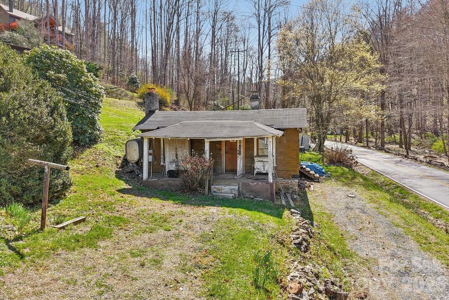 Is there a single family home in Waynesville with redevelopment potential and utilities already in place? 719 Camp Branch Road sits on 0.316 acres and has been taken down to the studs, offering a clean slate for investors or builders. City water is connected, septic is in place, and sewer access is available through the Town of Waynesville for a tap fee. Home is being sold as is and financing other than cash will be difficult. Close to the updated Waynesville Country Club.

Single family home in Waynesville NC offering a rare value add opportunity just minutes from downtown. Originally built in 1936, this property is ready for a full renovation or rebuild. The home is not livable in its current condition, with studs exposed, providing a true blank slate for your vision. The existing structure has been stripped down, allowing you to design and finish to your exact specifications. Situated on a 0.316 acre lot with no HOA, the property offers flexibility for a variety of potential uses. City water is already connected, and the current septic system is in place, with the option to connect to sewer through the Town of Waynesville for a tap fee. There may be potential for an additional dwelling unit, ADU, with Town of Waynesville approval. Ideal for investors, builders, or buyers looking to create a custom mountain home or income producing property. Convenient location near downtown Waynesville, local dining, shopping, and access to major routes. Bring your vision and unlock the full potential of this property.