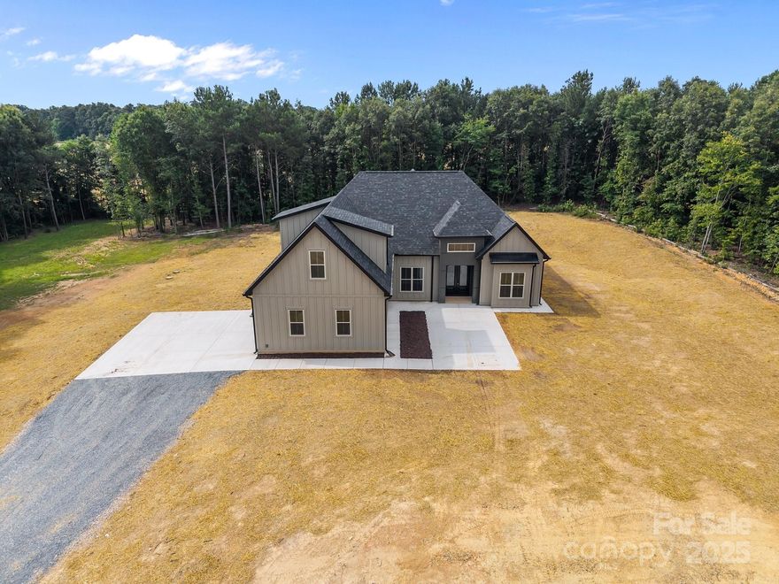 Luxury-grade build in Peachland NC! This deliciously designed BRAND NEW home sits on a 8+ acre tract of scenic Peachland countryside. Elegant wooden doors and a cute covered porch provide a grand welcome. Open and airy floor-plan lets the light pour in. 10' ceilings throughout main floor, with soaring vaulted ceiling in great-room. GORGEOUS kitchen and cabinetry fit for a chef, with quartz countertops and stainless steel appliances. Large primary en-suite features a tray-ceiling. Primary bath includes a dual-vanity, spacious walk-in shower and soaker tub. Walk-in closet upgraded with built-ins. Convenient mud-room at garage entrance. Delightful laundry room with cabinet space. Upstairs bonus/bedroom includes a full bathroom. Huge rear covered porch provides ample space to bathe in the serenity of nature. No HOA! Home is pre-wired for Generac generator. Peaceful and quiet location with with so much to offer!