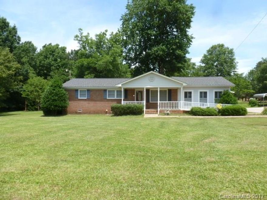 Peace and Quiet in the country on 3.62 acres. Nice brick home features large country front porch, vaulted ceiling in the den with hardwood floors also fireplace with gas logs, kitchen updated with custom cabinets, all appliances remain, dining room off of kitchen, 3BR, 2.5BA. Lots of natural light, sunroom, new gas pack and with handicap access.