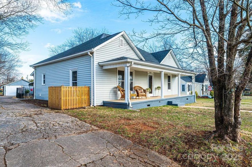 Sidewalks!  A front porch AND a back porch!  Walking distance to parks, gyms, restaurants, coffee shops and shopping!  This two bedroom, two bath home is perfect for the buyer who wants to live "in town" and enjoy a move-in ready home!  The central area of this home is perfect for congregating.  Use it as a dining hall, a living room, a play room or an office.  And then off of the central room on each side is a large bedroom room and a full bath.  The kitchen is spacious enough for an island and has its own little nook which can be a perfect pantry, a craft space or even a little office.  The den off of the kitchen is the perfect spot to cozy up and watch TV.  Tall ceilings and wide molding are reminiscent of homes built in this era. New flooring, paint, light fixtures, gas tankless water heater and more are what awaits you.  Fenced in back yard and a separate fenced in dog area make enjoying the outside easy!  Two-car detached carport has lighting as well as the oversized shed!
