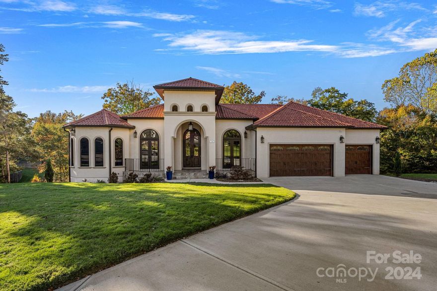 Discover this stunning waterfront, 5-bedroom, 8 bath Mediterranean-style home at River Lake, Tega Cay, with breathtaking Lake Wylie views, spanning 6,068 sqft on a double shoreline lot. As you enter through the impressive 300 lb front doors, you'll be greeted by a contemporary luxury living space on the upper level. Privacy is ensured with four en-suite bedrooms, and both primary bedrooms open to mesmerizing lake views. Inside, find luxury features like soaring ceilings, retractable glass, soundproof doors, an Italian marble fireplace, Electrolux and Bosch appliances, quartzite countertops, dog wash station and more. The lower level is designed for entertainment, offering two bedrooms, a second laundry room, a family room, gym, wine room, and bar.  Outdoors, endless possibilities await with Lake Wylie at your doorstep, and a public boat launch at Niven's Creek Landing is nearby. This property will be off market until 3/1/24.  Boat dock permit is approved.