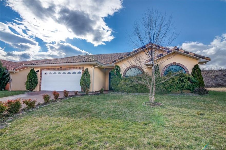 Tuscan design brings Mediterranean charm to this modern, sleek interior. This lock and go community has lawn care included for easy living. Set apart with full glassed Carolina sun room and dining room overlooking fenced private yard. Chefs kitchen with granite, glass-tiled back splash, and full set of appliances. This home inspires you from artist fireplace , interior archways, cathedral ceilings, and stone accent windows. Mountain views and sidewalks in neighborhood.  One not to be missed!