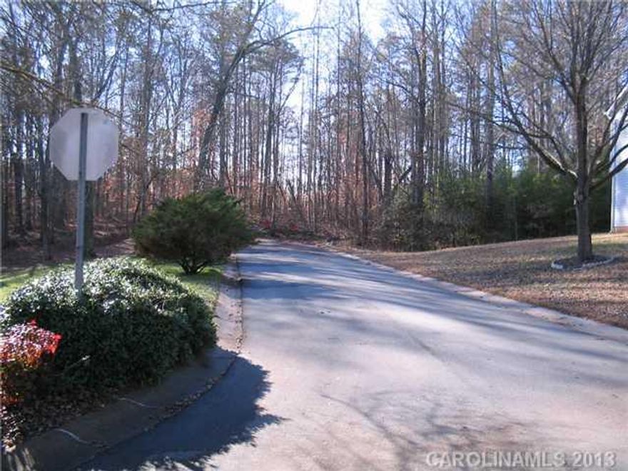A unique lot potential for your dream home on an approximately two acre lot accessed via the Amberwood subdivision.  Lot is not a part of Amberwood so there are no HOA dues, rules or regulations.  City water and city sewer is available per the seller.  Lot also borders a small cul de sac of newer homes accessed directly from Plott Road.  Private and wooded lot.