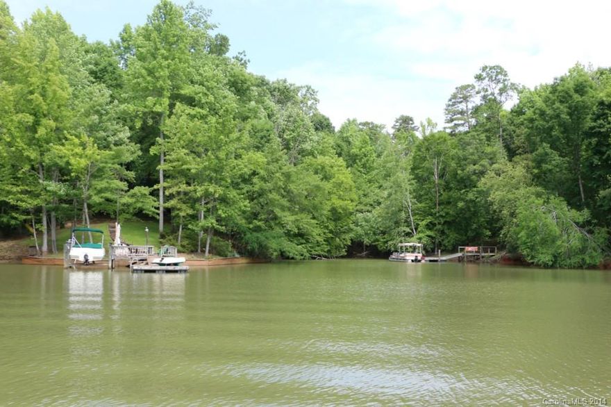 Enjoy serene lakefront living on this large wooded homesite!  Excellent Fort Mill schools, great location for commute into Charlotte.  Waterfront Lake Wylie, located on the Torrence Creek channel, perfect for watersports and paddling around.  Heavily wooded lot, private estate-sized home site.  Lot is in the back of a wide cove, presenting excellent view potential.  Gentle topography, great for building.