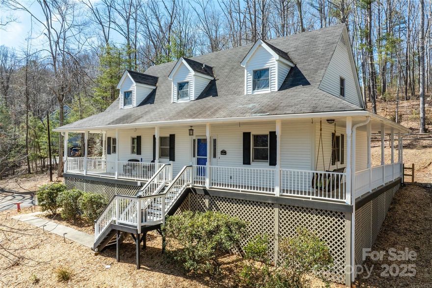 Beautiful home on 1+ acre with fenced backyard. Enjoy the conveniences of downtown Asheville just minutes away but with no city taxes. Cafe line appliances, walk-in pantry with coffee bar are some of the features in newly renovated kitchen.  The main level features beautiful Hickory hardwood floors, large laundry room and primary bedroom. Wrap around covered porch great for enjoying winter mountain views or relaxing in the shade on a summer day.  Contemporary gas fireplace.  Large double car basement garage has plenty of room for a workshop. Lots of storage throughout the home highlighted by walk-in closets in all bedroom. Stove has 6 gas top burners and two electric ovens.  Upstairs bathroom is a Jack and Jill layout.  Public sewer and private well. Above ground propane tank is leased. Refrigerator in basement conveys.  Water filtration system on the well.