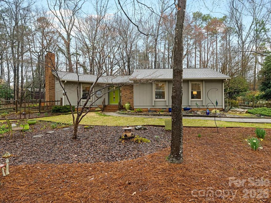 Charming gem of a one-level home on a large shady lot at the end of a quiet street in South Charlotte. Beautifully maintained property boasts gorgeous landscaping with a mix of annuals and perennials in extensive planting beds and a lovely pond with waterfall adjacent to the spacious rear screened porch. Vaulted great room has windows on 3 sides, centered on a fireplace flanked by custom built-ins. Great flow in the living spaces--great room and dining room open onto side deck; screened porch is off the dining room, which is currently being used as a den; kitchen is in the heart of the house, overlooking the rear yard. Bedroom wing includes primary suite with walk-in closet, two additional bedrooms, hall bath with tub and a laundry room with great storage. Recent updates include 2022 roof and 2023 HVAC.