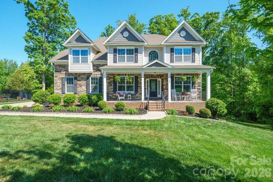 Welcome to refined comfort in Shinnville Ridge, Mooresville.

Set within one of Mooresville's most desirable communities, this beautifully maintained 6-bedroom, 5.5-bath residence sits on over half an acre and delivers an exceptional balance of elegance, flexibility, and everyday livability.

From the moment you arrive, the home's curb appeal makes a strong impression. Classic stone accents complement the hardboard siding, while a wide driveway leads to a 2-car garage.

The outdoor living spaces are equally inviting, featuring a walkout basement and a fully screened-in deck with a serene, "tree-house" feel overlooking the fire pit and tree line - an ideal backdrop for either lively gatherings or quiet evenings at home.

Inside, the main level offers generous side rooms, a full bedroom and bath well suited for guests or multigenerational living, and an expansive open-concept layout connecting the kitchen, living room, and breakfast nook. The kitchen truly shines, showcasing matching stainless-steel appliances, beautiful white cabinetry, a spacious walk-in pantry, and a stylish butler's coffee bar that adds both function and personality.

The upstairs level is thoughtfully designed with four additional bedrooms, a large and versatile bonus room, and a conveniently located laundry room. The primary suite serves as a private retreat, featuring its own lounge area, two walk-in closets, and an additional closet or sitting space for added flexibility. The spa-inspired bath elevates everyday routines with a soaking tub, fully tiled shower, and private water closet.

The fully finished basement expands the home's possibilities even further and could easily function as a home within a home. A very spacious living area is complemented by multiple bonus rooms ideal for a studio, gym, office, or theater, along with a private bedroom and full bath. Whether you envision a photography studio, golf simulator, or an exceptional space for entertaining or hobbies, this level is ready to adapt to your lifestyle.

Conveniently located near shopping, dining, and major highways, this home delivers space, comfort, and versatility in a sought-after Mooresville setting. Come experience a home designed to grow with you - and to impress at every turn.
