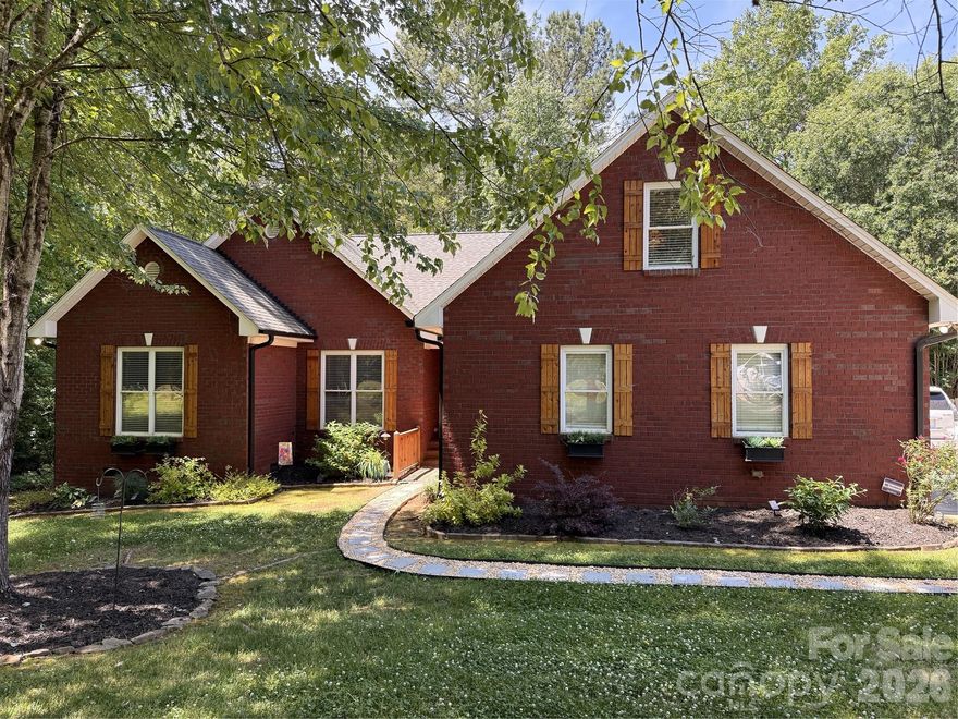 Welcome to this enchanting brick home situated on a picturesque .82 lot! The current owner - AND - only owner has taken meticulous care of this home and property; KEY highlights include: NEW Roof coming this May (2026), Heat Pump & A/C (2024), Well Pump & Fence (2023) and an Encapsulated Crawl Space (2021). As you enter this home you'll notice the gleaming hardwood floors that run throughout and lead you into your cozy Living Room! Just beyond this room, you will gaze and fall in love your expansive screened-in porch (333 sq. ft.) which offers a delightful area to entertain in - or - to simply relax in with a refreshing beverage and a great book! The stunning Kitchen is a chef's delight with its deep and dramatic cabinetry, granite counters and stainless steel appliances! The Refrigerator conveys as well so you are all set! The Primary Bedroom is a true retreat and just steps away from that incredible porch! Of course, there's an en suite Bathroom with dual vanities, garden tub, shower and a spacious walk-in closet. The Guest Room and another Full Bathroom are on the other side of the home so everyone has privacy. The upstairs Bonus Room can be a game room, exercise room, etc. - you decide! The over-sized garage offers a finishing touch with its epoxy flooring. Water filtration system. This home and property is a must-see as it truly is a blend of comfort, style and enjoyment of the beautiful outdoors! Note: Professional pictures to be done once roof is completed.
