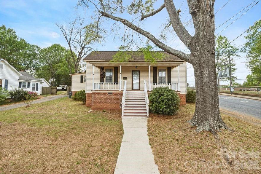 Adorable bungalow on .27 acre corner lot. Within walking distance to downtown Kannapolis, Cannon Baller Stadium, NC Research Campus, Shopping, Dining and more. Features include the refrigerator, gorgeous hardwood floors, some of the linoleum flooring was updated in 2022, beautifully redone bathroom with tiled shower area, new heat pump in 2021, new roof in 2011, new water heater in 2019. A few insulated windows. Rocking chair front porch, detached 2 car carport. Shared driveway entrance. City water and sewer. Seller is a licensed real estate agent in NC.