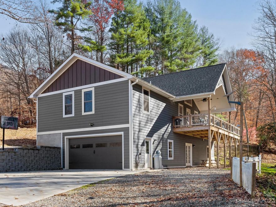 Excellent craftsmanship & location for this 1-story home w/ 3 bedrooms, 3 full baths, bonus room, fabulous finished basement space, & creek running through the back of this gorgeous .53-acre yard. Built in 2020, this home is well-appointed, inviting, & wonderfully accommodating. The main level touts a fantastic open floor plan w/ vaulted knotty pine ceiling, gas logs fireplace, dining area plus a tastefully designed kitchen w/ stainless steel appliances, kitchen island w/ breakfast bar, & remarkable designs & niceties. The covered back deck overlooks a creek to maximize outdoor enjoyment & tranquility. You'll appreciate tremendous additional space in the finished basement area w/ huge recreation/family room, bonus room w/ walk-in closet, & full bath. Highlights include attached 2-car garage, winter mountain views, woodsy backyard, & multiple areas to enjoy the stunning natural setting. Short-term rentals allowed! Spectacular location convenient to BR Parkway & downtown Weaverville!
