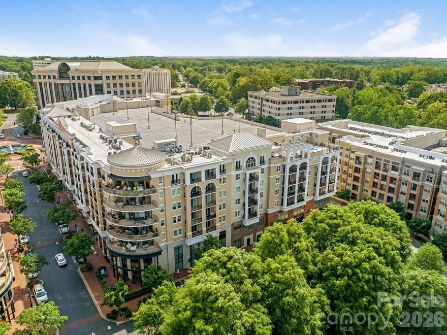 Fabulous one-bedroom condo with great flex space! Kitchen has 2026 appliances, generous counter & cabinet space, under-cabinet lighting & bright pendant lights over the island to make food prep a breeze. The open floor plan offers so many options for furniture configuration-- a spacious living area, a dining area & a bonus room that can be an office, a TV room, a workout space--you name it! The bedroom includes an en suite bathroom with new countertop, stall shower and walk-in closet. Sliding door from the living area opens onto a covered balcony from which you can enjoy a western sunset view. Freshly painted with wood or tile floors throughout, a 2020 heat pump and 2026 water heater, it is move-in ready! Condo comes with one assigned parking space in gated owners' area & seven floors of guest parking--the most in Charlotte. Piedmont Town Center includes on-site restaurants (Peppervine, Bentley's, Duckworth's, Del Frisco's, Leo's, Mal Pan, Tous Les Jours Bakery, Milk Cha-Cha, Summit Coffee), fitness club and personal care venues (hair, nails, lashes, day spa). Welcome home!