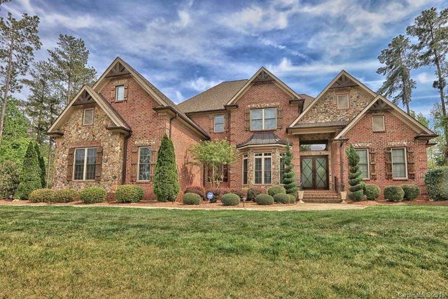 Stunning Oz Custom Home in Eppington South! Highly rated Fort Mill schools. Rare 4 car garage w/abundant storage. Beautiful custom features include heavy moldings, 10' ceilings, 8' ft doors, stacked stone fireplace, dual staircase w/wrought iron spindles & granite in baths. Dream kitchen that includes Jenn Air gas cook top, double ovens, walk in secret pantry, breakfast bar, tumbled marble backsplash, & hidden built in spice racks. Professionally landscaped 3/4 acre lot that is pool ready!