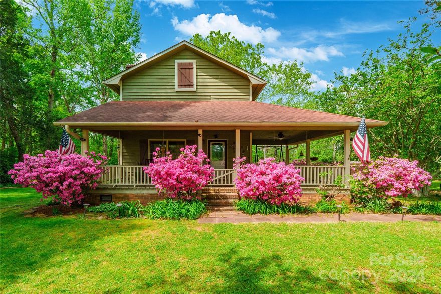 Escape to the serene charm of this idyllic country retreat on approximately 3.5 acres. .  As you arrive, you are greeted by a fountain and covered front porch, nestled amidst the lush greenery. Step inside to discover a kitchen that exudes rustic charm, boasting SS appliances and quartz countertops. The main level offers a spacious primary bedroom, complete with an attached bathroom featuring a dual vanity and an oversized shower adorned with two shower heads. Find comfort and convenience with two linen closets for ample storage. Journey upstairs to find the additional bedrooms and the upstairs bathroom with its own dual vanity and gorgeous claw bathtub. Outside, you will find a sprawling wrap around deck and a wired, 800 square foot, two-story workshop standing as a haven for creativity & productivity, while a detached metal garage provides space for your vehicles and storage needs. A tranquil pond graces the landscape, home to brown bass and catfish!