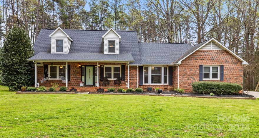 Welcome home! This charming 3-bedroom, 2-bath brick home welcomes you with open arms. Close to everything Rock Hill offers!! No HOA!! The primary bedroom is on the main floor and there is a walk in attic off the bonus room upstairs. You will find a spacious kitchen with ample counter space, perfect for both culinary creativity and gathering with loved ones. Step outside onto the expansive yard, complete with a cozy swing for two, inviting you to unwind by the fire pit and relax in nature. A covered front porch brings to mind lazy afternoons and warm welcomes, while the home, nestled amidst the beauty of a mature tree-lined neighborhood, offers a peaceful retreat from the world, calling you to make cherished memories in every corner.