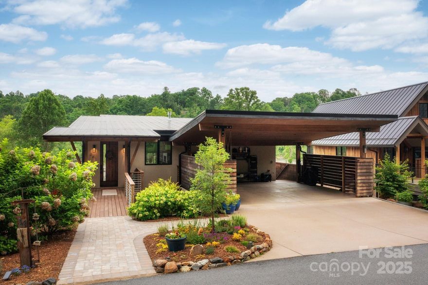 You didn’t come to the mountains just for a house. You came for this—a home rooted beside the river, where morning light dances through 13-foot windows and the rhythm of the French Broad sets the pace for your day. Designed with intention and crafted with elegance, this modern sanctuary is as connected to the land as it is to your lifestyle. Custom cabinetry, quartz counters, and curated appliances anchor a kitchen built for gathering. The open living space flows like the river itself—seamless, alive, and luminous. The main-level primary suite offers spa-like serenity; downstairs, a second living area with wine bar, three bedrooms, and access to riverside trails and a backyard that blends into nature. Sustainable living unfolds in Olivette—past gardens and a working organic farm, through a network of parks & paths, to a dog park, a pickleball court, and a vibrant, intentional community. Built with vision, balance, and deep respect for the environment—all just 15 minutes from downtown.