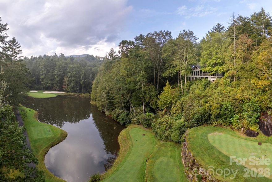 Privacy, River, Mountain, & Golf Course Views! Enjoy spectacular views from nearly every room in this beautiful home, perfectly positioned on a large, private lot at the end of Winding Creek. Overlooking the pond at the 17th hole of Burlingame Golf Course & the scenic Horsepasture River, this property offers the ultimate in peace, privacy & year-round living. The spacious great room features soaring cathedral ceiling, exposed wood beams, a stunning stone-faced gas fireplace, built-in shelving, bar area, & skylights that flood the space with natural light—creating a warm & inviting atmosphere in any season. Step into the View room.  Enjoy the Mendota gas fireplace, with its special light features, thermostat. Dining area is complete w/panoramic windows that frame the surrounding natural beauty. It’s a serene space that brings the outdoors in & is perfect for relaxing or entertaining. The well-appointed kitchen includes an eat-in area, ample workspace & a built-in hutch. This connects to the laundry room with sink, storage pantry with appliance bays & an extra refrigerator-all leading to the attached two-car garage. This home offers a desirable split floor plan, featuring a spacious master suite w/private access to the outdoor patio. Master bath includes dual sinks, soaking tub, separate shower, and plenty of storage. The guest suite includes an adjoining office/den or additional sleeping & a full bath with make-up vanity. All main-level living ensures ease and comfort, but if you need additional space; New upper-level bedroom w/private full bath with its own balcony overlooking the views is great in providing additional comfort and flexibility for guests or family. A finished area beneath the home with windows. A separate entrance makes for a perfect workshop, storage space, or hobby area. Outdoor living is just as impressive, 5 covered/open decks, & ample room for entertaining, grilling, or simply relaxing while taking in the tranquil sounds of the Horsepasture River and the 17th green. To the right of the home is an additional lot that is included in the acreage, but it can be separated & sold for another residence. See List of all updates: including roof, kitchen, bed, baths, heat pump-both electric & propane and more!  Come experience the beauty & serenity of mountain living. Burlingame Country Club membership is optional & is by invitation and acceptance. Some amenities only available with Club Membership.