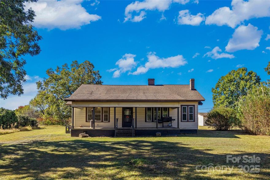 Imagine stepping back to a simpler time without sacrificing modern comfort. Nestled on +/-2.55 acres of idyllic countryside in McConnells, this beautifully preserved farmhouse, dating back to just after WWI, is more than a home—it's a peaceful country retreat. Picture yourself winding down on the expansive rocking chair front porch, soaking in the serene views and quiet moments. Inside, the charm unfolds in the living room, where coffered ceilings and a stately wood-burning fireplace create a cozy, captivating atmosphere perfect for gathering. A spacious dining room awaits your next celebration, while a dedicated small office provides a quiet nook for focus. You can rest easy knowing major updates are complete, including a new HVAC system (2021), an encapsulated crawl space, and updated electrical and plumbing. Complete with two storage buildings, this timeless property offers both character and convenience. Ready to trade the hustle for the harmonious? Your dream country lifestyle awaits.