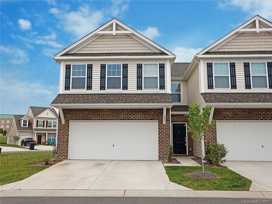 ABSOLUTELY  Gorgeous, Almost Brand New, End Unit Townhome Facing the Lake! Warm, inviting, modern flair: 9' ceilings w/crown molding, gray cabinetry w/under lighting, granite in Kit & Master Bath, SS appl. in Kitchen, rustic industrial style lighting, dark hardwds on main, & computer niche. Drop Zone & Laundry Rm. Versatile Loft. Back Patio & Green Space! Fabulous community Pool area! 2 Car Garage & additional parking nearby. This is one of a kind in Ft Mill School District that won't last long!