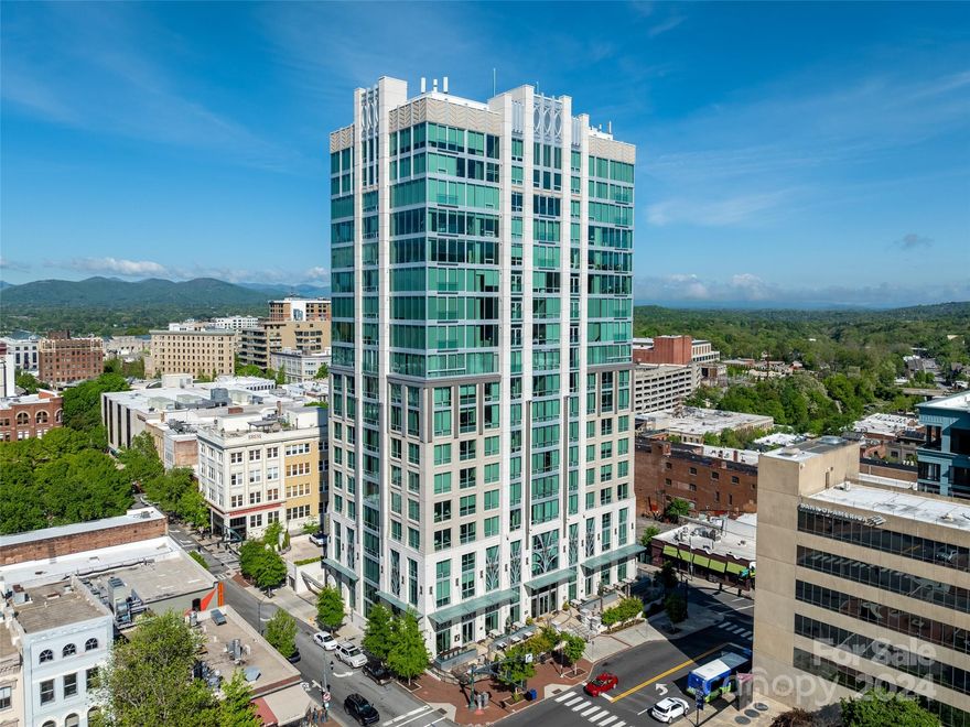 Discover unparalleled luxury at The Arras Residences, perfectly situated in the bustling heart of Downtown Asheville. This 2-bedroom, 2.5-bathroom, one-level unit is one of only three of its kind in the entire development.

Awe-inspiring mountain panoramas are visible from expansive floor-to-ceiling windows, casting natural light upon the meticulously designed interiors. Cozy up by the inviting gas fireplace in the spacious living area, sporting a chef's kitchen with upgraded kitchen appliances and custom cabinetry. With lofty 10-foot ceilings, the open floor plan creates an inviting ambiance perfect for both relaxation and entertaining.

Convenience is seamlessly woven into the fabric of daily life at The Arras Residences, with a designated garage parking spot and a private entrance reserved exclusively for residents. Dine at the lobby bar and restaurant anytime, and enjoy a resident happy hour daily from 4-6.
