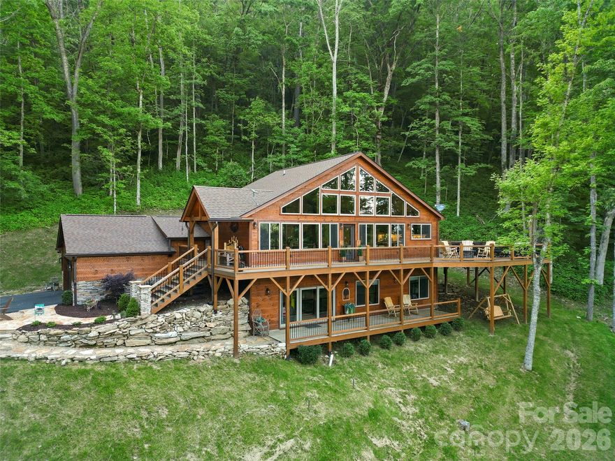 Stunning custom mountain retreat in the gated Smoky Mountain Retreat at Eagles Nest community offers the perfect blend of luxury, privacy, and investment potential. Situated on 1.42 acres with breathtaking mountain views, this 4-bedroom, 3.5-bath home features a fully finished walk-out basement—ideal for entertaining or maximizing short-term rental income. Thoughtfully designed with no expense spared, the home showcases modern finishes, a gas fireplace, and seamless indoor-outdoor living. Enjoy the serene surroundings from the spacious deck and hot tub. Sold mostly furnished, this turnkey property is ready for immediate enjoyment or rental use. Located within a gated community with private roads and well-maintained common areas—and not located in a flood zone—this home offers both peace of mind and exceptional value in one of Maggie Valley’s most desirable mountain settings. A truly special mountain escape!