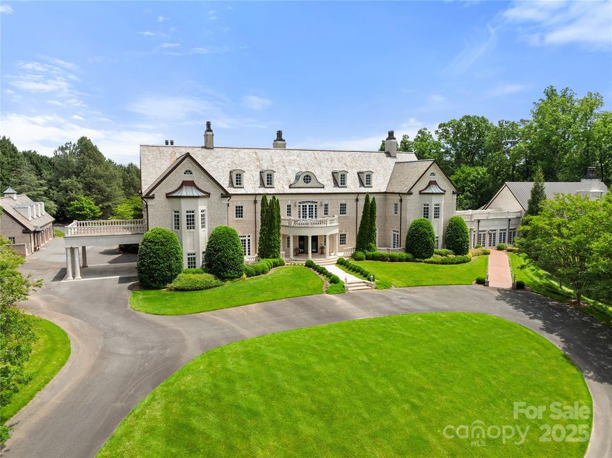 A rare offering of timeless sophistication, this privately gated estate is nestled on 7.22 manicured acres in the heart of Buena Vista. Built in 2002, the residence showcases a grand foyer, Brazilian cherry flooring, 10 gas fireplaces, and a luxurious primary suite with dual bathrooms & closets, each with heated floors. Four additional bedrooms all with en-suite bathrooms are located in the main house. Designed for refined entertaining, the home features a formal dining room, chef’s kitchen, and expansive verandas with skyline views. Resort-style amenities include a heated indoor pool and an elegant event space with cathedral ceilings, copper roof, and capacity for 120 guests. Outdoor highlights include a saltwater pool, lap pool, multiple patios, and a beautifully landscaped lawn. A full pool house and garage apartment offer complete guest accommodations. With dual gated entrances, this legacy estate is unmatched in privacy and distinction and is minutes from downtown Winston-Salem.