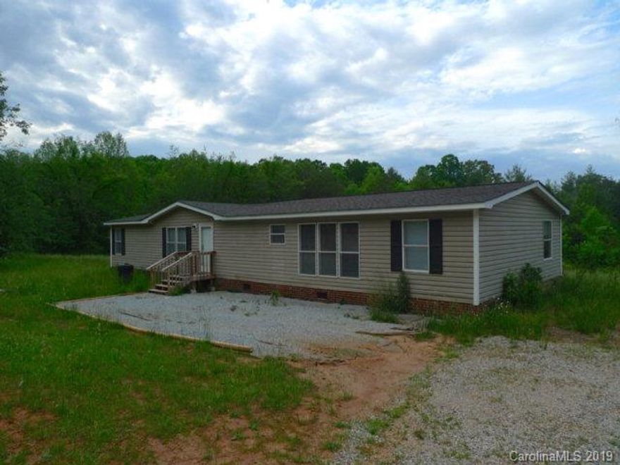 Very private double wide on 5.7 acres. Large kitchen/dining area, large living room. Split bedroom plan with large master suite and three bedrooms with hall bath. Level acreage with some clearing.