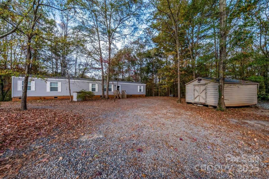Experience comfortable living on this one-acre lot featuring a well-kept 2022 single-wide mobile home with 3 bedrooms and 2 bathrooms, conveniently located close to I-77 for quick access to shopping and dining. Situated just outside the city limits with no HOA, this property offers both freedom and convenience.

Enjoy peaceful privacy with mature woods along the back of the property, creating a quiet, natural backdrop. Inside, the bright open floor plan highlights a large kitchen with lots of counter tops, a kitchen island, refrigerator, white appliances along with a freshly painted interior that feels clean and move-in ready.

The primary suite includes a walk in closet, bath features a garden tub, separate shower, and double sinks, providing a comfortable and functional layout.

Step outside to enjoy the front and back decks and storm doors.  Make use of the storage building for tools, equipment, or hobbies.

Move-in ready with space, privacy, and modern comforts—this home is an excellent opportunity close to everyday conveniences including I77.