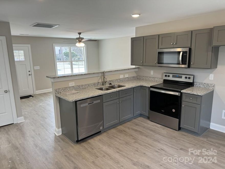 New construction! The kitchen features custom-built cabinets with Shaker doors, granite countertops in the kitchen & baths. Nice baseboards and trimmed-out windows. LVP Plank Vinyl flooring at Great Room, Dining, Kitchen, Breakfast, Laundry, all baths; carpet in bedrooms. Stainless steel appliances inc. Dishwasher, microwave, and smooth top range. Many upgrades for this price point, custom finishes. Ready to Move-in. Minutes from downtown Kannapolis & major highways.