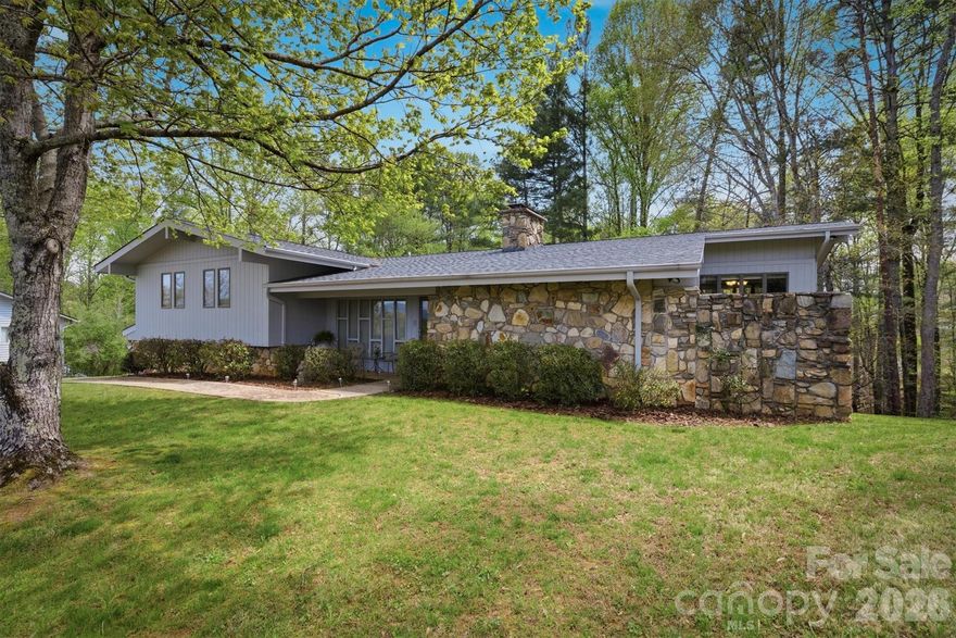 Set in a highly desirable location just across the street from the Marion Lake Club golf course, this inviting property offers the perfect blend of comfort, character, and everyday convenience in the heart of Lake James living. Positioned on a 0.70 acre lot with a mix of open yard and wooded surroundings, the setting feels both private and connected, enhanced by beautiful views of iconic Shortoff Mountain and Dobson’s Knob rising in the distance. 

Inside, the home showcases a distinctive retro charm reminiscent of classic mid century design, with a warm and inviting feel that stands apart from today’s more typical builds. Rich wood tones, unique architectural lines, and an abundance of natural light create a space that feels both nostalgic and full of personality.

One of the standout features throughout the home is the extensive use of beautiful stonework, anchoring multiple living areas with timeless texture and character. From the striking fireplaces to interior accents, these details add depth and a level of craftsmanship that is increasingly rare. The main and upper levels offer an easy flow between the living room, dining area, and kitchen, creating comfortable spaces for gathering and everyday living. 

With four bedrooms and three full bathrooms, the home provides plenty of room for family and guests. The primary suite offers a quiet retreat, while additional bedrooms and flexible spaces allow for a home office, creative studio, or overflow accommodations. A well designed laundry area and generous storage further enhance functionality. 

The lower level expands the living space with a partially finished basement featuring a large den, additional bedroom, and full bath, ideal for guests, recreation, or multi generational living. With walk out access, this level connects seamlessly to the outdoors and offers even more versatility. 

Outdoor living is just as appealing, with covered and open deck spaces that invite you to relax, dine, or entertain while taking in the layered mountain views. Whether enjoying your morning coffee with Shortoff Mountain in the distance or winding down in the evening as the light fades over Dobson’s Knob, these outdoor areas provide a truly special vantage point. 

Adding to its appeal, the home sits directly across from the Marion Lake Club, a semi private golf course, offering convenient access for golf enthusiasts and a scenic, open backdrop that enhances the overall setting. A dedicated utility space perfect for a golf cart makes it easy to take full advantage of the course, creating an ideal setup for buyers seeking both golf and lake life.

Located just 1.7 miles from a public boat ramp and only 0.8 miles from Lake James State Park, this property offers quick and easy access to some of the area’s best outdoor recreation, from boating and fishing to hiking and biking. Combined with nearby marinas and the charming downtowns of Marion and Morganton, this location delivers an exceptional balance of convenience and lifestyle.

With over 3,000 square feet of living space, a two car garage, and unmistakable character throughout, this property presents an exceptional opportunity for a full time residence, second home, or investment. For those who appreciate a home with personality, craftsmanship, and a story to tell, this one is truly something special.