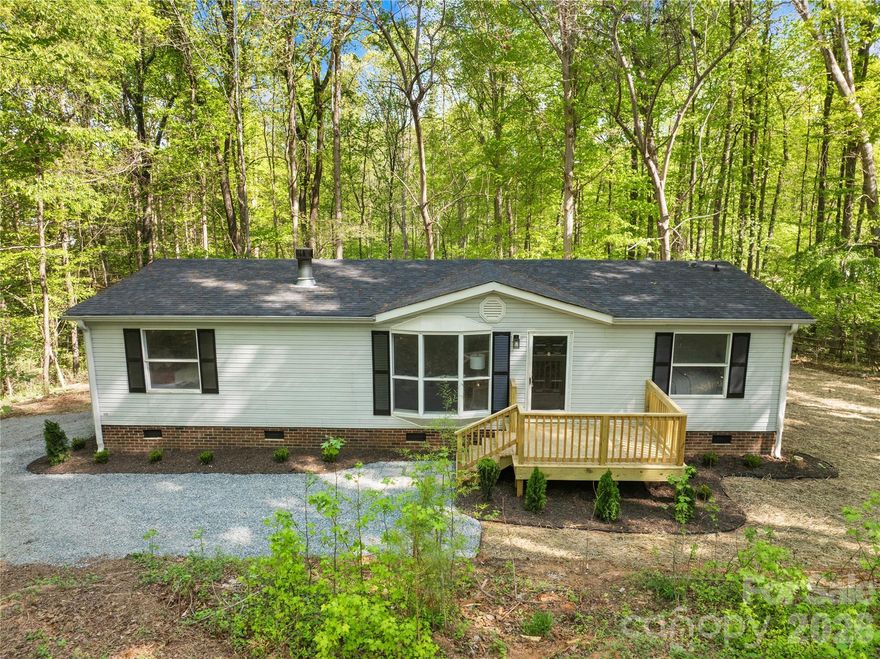 Beautifully updated home situated on a private wooded lot in Cabarrus co, offering the perfect combination of modern updates and peaceful surroundings. This move-in-ready Midland property features brand-new flooring, fresh paint, and updated fixtures throughout. The spacious living room showcases a stunning stone fireplace, creating a warm and inviting focal point. The fully updated kitchen includes new cabinetry, countertops, and stainless steel appliances, along with ample workspace and natural light. Enjoy outdoor living with all-new decks on the front, side, and rear of the home, providing multiple spaces to relax or entertain while overlooking the serene wooded setting. Additional recent improvements include a brand-new roof completed this month, offering added peace of mind for years to come. Agent related to seller. The property also includes fresh landscape, a detached storage shed and a generous lot with plenty of privacy. Make your Showing appointment today.