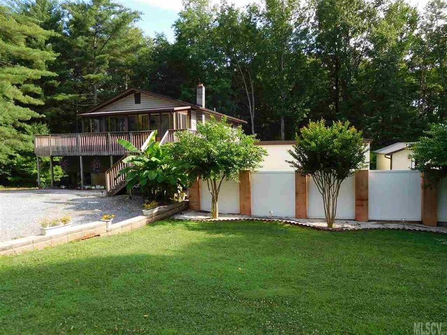 This immaculately maintained and updated, one of a kind, two bedroom and two bathroom home is full of custom features and is perfect for entertaining. The outside feels like a private resort. There is an in-ground Baquacil pool that's surrounded by a custom privacy fence.  There are two nice, large outbuildings for your extra storage needs. Inside the home, the main level is an open floor plan with hardwood floors and ceramic tile. It has an updated kitchen with custom kitchen cabinetry, fantastic dining area and living room with access to private rear deck. It also features a gorgeous staircase leading upstairs to a sublime master suite that can handle all your large furniture and features a customized walk in closet. The second bedroom suite is also a nice size and has access to a cooled sun-room. Home also has a super sized utility room with gas logs for heating and could be converted to additional living space with a little effort. There are really just too many features to list!