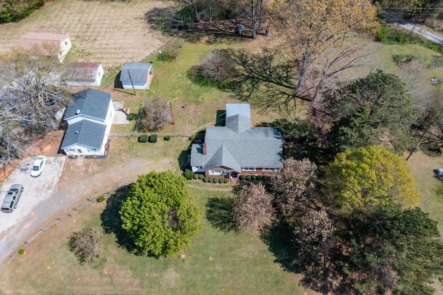 AWESOME OPPORTUNITY - Main house with (ADU) Additional Rental Unit for sale! This sale includes BOTH homes. 
MAIN HOUSE has 1559 sf, 2 br/1ba. Spacious living room, gas logs, den, large eat-in kitchen, separate dining room, covered back porch. Hardwood floors underneath the carpets. HVAC unit 2yrs old on main house. Fenced in backyard & open shed. This home is ready for your unique touch!  

RENTAL HOUSE has 1412 sf & detached from main property. Separate Utilities. 2br/1ba, office area, full kitchen, bathroom w/ laundry facility, large living room. COMPLETELY FURNISHED & all furniture/appliances present at time of showing will convey. It is believed the well and septic are shared between the two dwelling units. 
SELLING AS IS. 

Total Square footage for both residences is 2971. Buyer to verify zoning, square footage, schools and anything of importance.