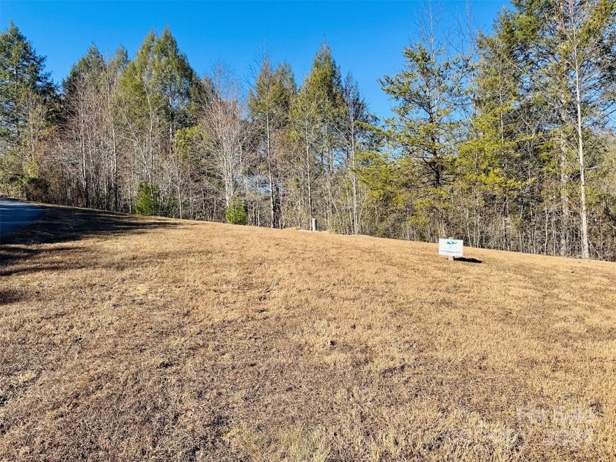 Build your dream home on 1.3 acres at The Coves Mountain River Club, an Outdoor Lifestyle Community like no other.  Seller including home plans and topo maps designed for the site.  The well for the home is installed and a 3 bedroom septic permit was obtained. The Coves is a 3,200 acre gated community on 5 miles of the Johns River, minutes from Lenoir, Blowing Rock, and Morganton NC and the Blue Ridge Parkway.  Hike, bike, ride horses/UTVs on miles of community exclusive trails.  Enjoy the post and beam constructed clubhouse on one of the highest peaks: panoramic views of the Brushy Mtns, Blue Ridge Mtns, and South Mtns; wrap around decks/porches on 2 levels, great room w/vaulted ceilings, 3-sided fireplace, kitchen, pool table, fitness center, locker rooms, outdoor fire pits.  Wyatt's Park has pickle-ball courts, putting green and picnic pavilion.  Additional amenities include 2 equestrian centers, more picnic pavilions, community garden and vineyard.  Over 30 clubs to join!