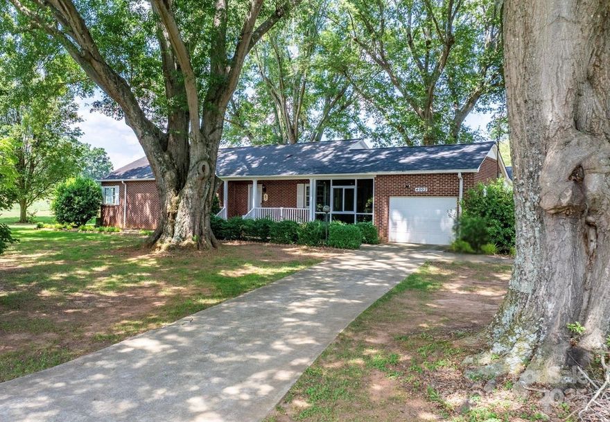 A truly unique property! All-brick ranch in Granite Falls situated on over 1.4 acres with mature landscaping and 250+ ft of road frontage on Hwy 321. This 3 bed, 3 bath home features a spacious layout with original hardwood floors, full unfinished basement, and two large enclosed porches/sunrooms with gas heaters for year-round enjoyment. A standout feature is the detached garage/workshop offering over 3,500 sq ft, including 9 garage bays and a half bath—perfect for auto work, storage, or a variety of business uses. Also included is a fully equipped beauty salon with its own half bath, ideal for a stylist or beautician looking to work from home. Zoned Highway Business, this property offers incredible flexibility for residential, commercial, or mixed use. With prime visibility and endless potential, this is a rare opportunity you don’t want to miss!