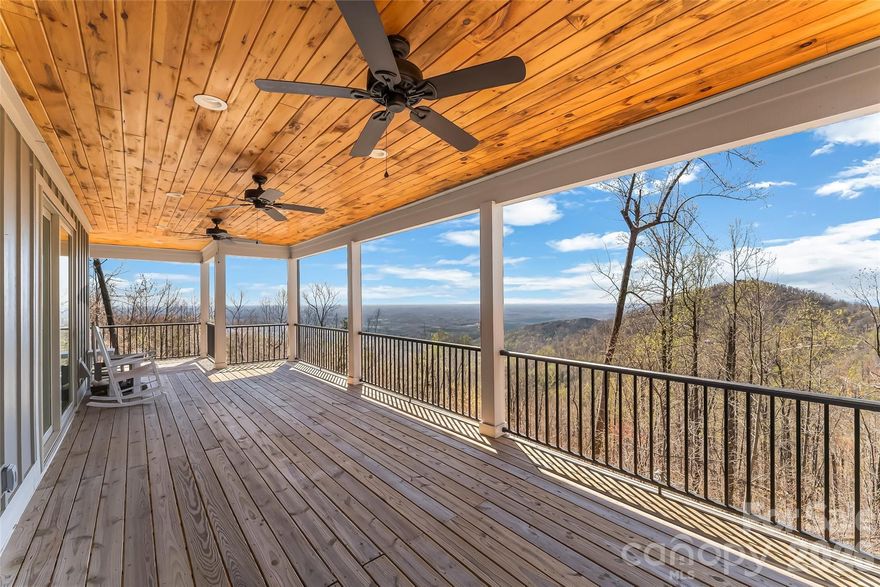 Commanding the summit of Pinnacle Mountain, this exceptional 2022 modern farmhouse delivers truly breathtaking, long-range mountain views across 4.29 private acres. Designed to impress and built for elevated living, this 4-bedroom, 3.5-bath retreat seamlessly blends refined craftsmanship, modern comfort, and awe-inspiring natural beauty. The open-concept main level stuns with soaring vaulted ceilings, rich hardwood floors, a wood-burning fireplace, and walls of windows that frame endless layers of mountain vistas. The designer kitchen features stainless steel appliances, granite countertops, and effortless flow into the living and dining spaces—perfect for entertaining or simply taking in the views. The main-level primary suite is a serene escape with a walk-in closet, spa-inspired ensuite bath, and private access to the back deck where the scenery stretches for miles. Upstairs, two spacious guest bedrooms, a full bath, and ample storage provide comfort and flexibility. The finished lower level expands the home’s versatility with a large recreation room opening to a view-filled patio, along with a fourth bedroom and full bath—ideal for guests or multigenerational living. Offered fully furnished within a gated community, this home is perfectly suited for lock-and-leave convenience or short-term rentals. Convenient to Chimney Rock, Lake Lure, Marion, and an easy drive to Asheville via I-40, this rare mountaintop offering combines privacy, tranquility, and unforgettable views—an extraordinary opportunity to own a true piece of the mountains.