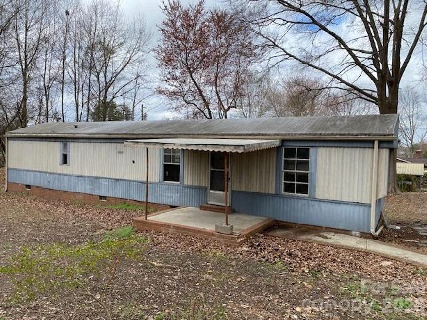 Spring is in the Air!  If you are looking for a FIXER UPPER on a nice flat piece of land (almost 3/4 of an acre), look no further!  This home boasts 728 sq ft of living space with two bedrooms and one bathroom, an open concept living room and kitchen.  It has been gutted on the inside and is a new canvas for someone looking for a project - maybe to live in or flip and sell.  Just a short distance to downtown Charlotte, and Charlotte Douglas International Airport, this is the perfect location - no HOA and a corner lot! Workshop with electricity also included on property, as well as a carport.  Pricing is FIRM! Priced to sell! This home can be restored or knock it down and rebuild.  This property is a diamond in the rough!  Come see it before it's SOLD!