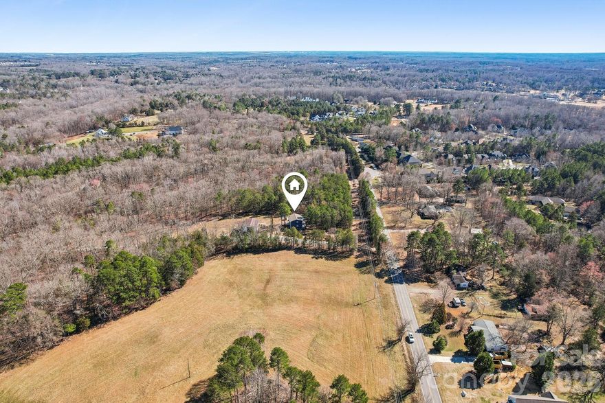 Looking to build a new home in a prime Davidson location with no HOA? This .79-acre lot has impressive building potential. The lot can be expanded to up to 1.07 acres for an additional cost. Located just a few miles from downtown Davidson! Enjoy watching deer, turkeys, and more forage on the vast surrounding property. Knock down the existing home and utilize the full potential of this conveniently located land. The homesite features a private driveway that winds through a picturesque corridor of trees. Aqua Pure water filtration system is already installed on the private well. The property has highly sought-after school districts. So much is coming to this area in Davidson soon, including Summit Farms, the expanding greenway to Fisher Farms, and more! See townofdavidson.org for more information.