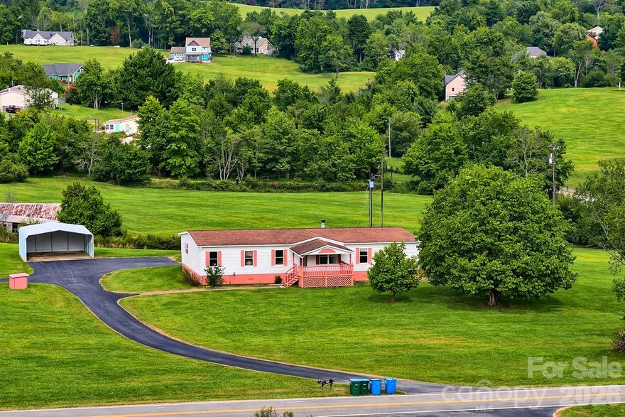 Gorgeous long-range Mountain views from this renovated 4 bedroom, 2 bath home with a carport on 1.99 fairly level acres. This is a fantastic sunny parcel in a terrific location which includes a 2/1, small-single-wide. Updated, beautiful kitchen cabinets, counters, double sink, stainless appliances, updated baths, newer laminate floors throughout. Drywall throughout and newer decking, front and back. Gas fireplace in family room, great open floor plan. Two covered decks and garden space and lots of land for gardening and creating a sanctuary. The lot is totally open and you can research adding other structures. Shared well and driveway for both homes. Each home has a separate PIN but is currently on one deed. There is a separate workshop located on the property. Make this home.