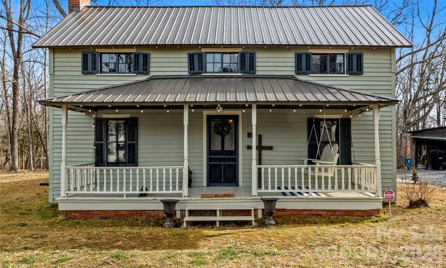 Looking for space to raise chickens, enjoy open land, or create the garden you’ve always wanted? This unique property offers just that—a historic home with modern updates on 6 picturesque acres less than 6 miles from I-40. The historically registered John Edward Belle Shutt home includes five outbuildings, fruit trees, a chicken run and coop, and a small creek/branch in the wooded corner of the property. This well-maintained, hand-crafted residence showcases rich history, with the rear one-story home and loft dating back to 1885 and the front story and jump home added in 1905. The two sections are connected by an enclosed breezeway featuring original porch flooring. Additional highlights include front and rear covered porches, seven LG Art Cool mini-split systems installed in 2022, cellar improvements, and a restored granary. A fully furnished tiny home is included and permitted as an accessory building with its own septic tank, offering flexible guest or supplemental living space.