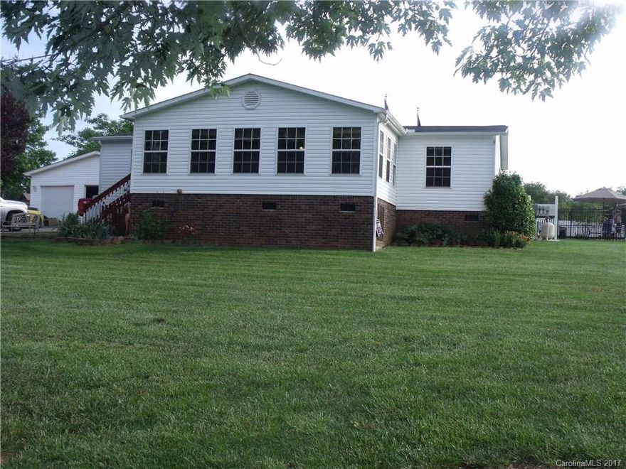 A must see!!! This home sits on 1.23 acres. Not far from Concord or Mt. Pleasant.  The kitchen, bathrooms have been updated. Almost the whole house has been .The front porch is covered and being used as a living room. It isn't heated or cooled. Has a three car garage with office. The shed has a nice little bar set up in it for party next to the pool.