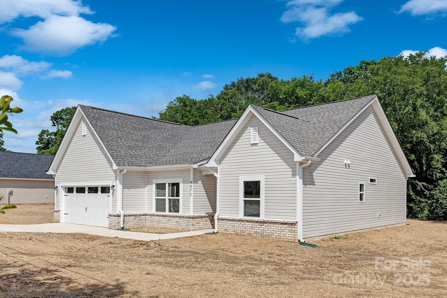 Discover the ideal combination of contemporary style and suburban charm in this brand-new ranch by Northway Homes, situated in the rapidly growing city of Concord, NC. Set on an expansive lot of over half an acre, this home provides plenty of space for outdoor gatherings, gardening, or simply relaxing in a tranquil environment. Conveniently located just minutes from Frank Liske Park, you'll enjoy quick access to trails, sports fields, and playgrounds—all while enjoying the peace of a residential neighborhood. Inside, you’ll find three spacious bedrooms and two full bathrooms, along with a bright and airy open-concept design that seamlessly connects the kitchen, living, and dining areas. The kitchen stands out with its modern finishes and practical layout, offering the perfect space for both everyday meals and entertaining. This thoughtfully designed home offers comfort, style, and space—all in a desirable Concord location.