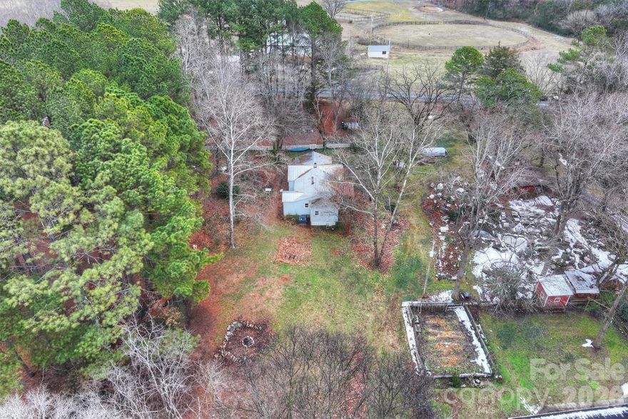 Ready to trade traffic and noise for fresh air and open skies? Your country dream starts here.

This charming 1940s home is tucked behind mature trees on nearly two acres, offering timeless character with original wood floors and a peaceful stream winding along the back of the property. The setting feels storybook — quiet, secluded, and surrounded by nature.

Start your mornings with coffee on the cozy covered porch, listening to birdsong instead of car horns. The partially wooded lot provides the perfect canvas for gardening, a hobby farm, all your animals, or simply creating your own private retreat.

Surrounded by rolling hills and picturesque horse farms, yet just minutes from quaint downtown Oakboro and Locust City Park, this property offers the rare balance of countryside serenity and small-town convenience.

Whether you envision a homestead lifestyle or a weekend escape from the city’s pace, this special property is ready for its next chapter — and yours.