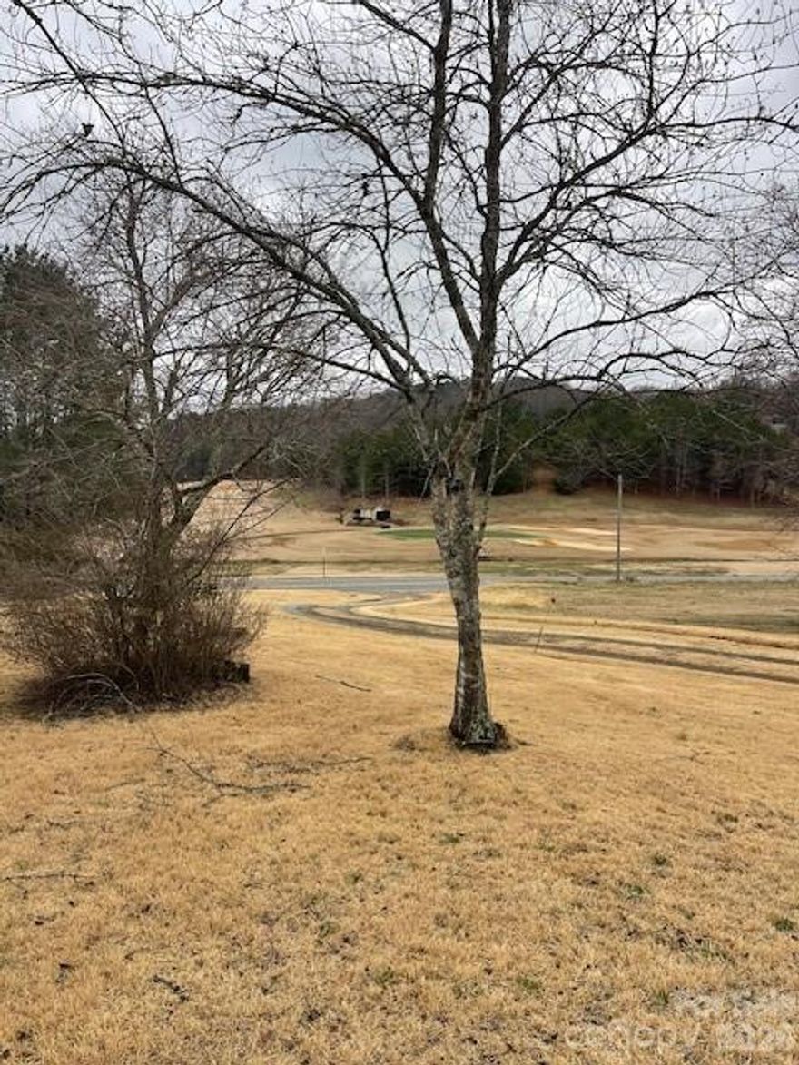 This 1.1-acre parcel offers many possibilities with its view of the Apple Valley Golf Course.  The older home near the top of the property is no longer habitable and holds no value.  Located just beyond the entrance to the golf course and within a mile of Rumbling Bald Resort and several public restaurants, the front of the parcel is easily accessible via Buffalo Creek Road, making it suitable for multi-family, single-family, or commercial projects.  The rear of the property borders the Stonecrest neighborhood.
This prime location is near Chimney Rock State Park, and the airports of Asheville NC, Greenville, SC and Charlotte NC, are within a 1 to 1.5-hour drive. The Tryon International Equestrian Center is located within an easy drive of approximately 20 minutes.