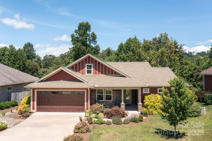 Discover easy living in this newer construction home in the sought after Reems Creek Village neighborhood, just minutes to downtown Weaverville and under 20 minutes to Asheville. Enjoy a functional floor plan with a level driveway and an attached garage for easy everyday access. The open concept living area features a stunning wall of windows that floods the space with natural light. The main level primary suite offers comfort and convenience, while a second ensuite bedroom provides privacy for guests. Upstairs, a finished bonus room above the garage makes the perfect studio, home office, or fitness space. Step outside to a covered back patio overlooking a private, nearly half-acre lot—ideal for entertaining, gardening, or simply enjoying the peaceful setting. An ideal blend of function, style, and location.