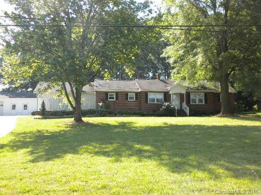 LOCATION, LOCATION!!  Charming older home that's had one owner! All brick with 2 BR's and 2 Bathrooms, cozy Den, eat-in kitchen, LR & large laundry room. Possible hardwoods under carpets, not confirmed. Tile in both baths. Refrigerator, freezer, washer/dryer remain.  Nice detached garage/shop for the handy people! All in sought after New Salem area.  Slightly over one acre has been surveyed out of 12 acre parcel.  ** Tax value reflects 12 acres. Affordable place to call home! Needs little TLC!