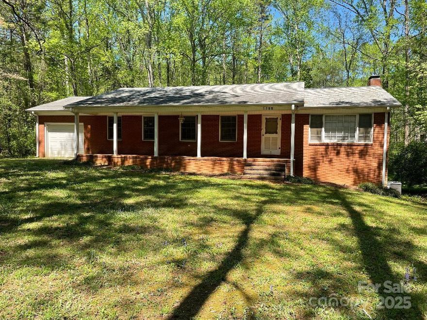 This "Gem in the Forest" is awaiting a new family. The home is perfect for the growing family with 4 bedrooms, living room, eat-in kitchen, 1 1/2 baths all on main level. (owner's choice of 4th bedroom/laundry) Easy entry to the main level through the attached garage or the rocking chair front porch. The fully finished basement has an amazing family room w/fireplace, full bath, kitchenette, laundry and storage rooms for family use as needed with 3 outside accesses. Over 2900 sq ft of heated space combined on main level with finished basement. A detached 24 X 24 double garage awaits the hobbyist in the family as a woodshop or mechanic's dream. Over 3 acres of land allows privacy for home gatherings with family and friends, much of the land in the natural state. This home has been a one family-owned home - meticulously maintained throughout the history of the home. Neighborhood naturally boasts of pride and privacy, no HOA, easy drive to Charlotte, Concord, Kannapolis, Huntersville.