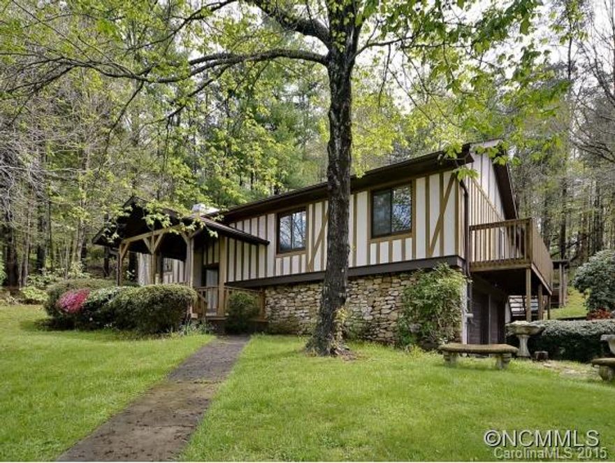 Unique property.  Beautiful Tudor style home with rock foundation.  Lovely yard completely fenced.  Has an apartment also on main level perfect for mother in law, complete with kitchen, laundry, great room and private entrance.  Full acre that has area for gardening and potential greenhouse on property.  2 heat pumps, 1 for apartment.  2nd laundry and additional room with wood stove, unfinished, plus large storage room in basement.  AS IS.