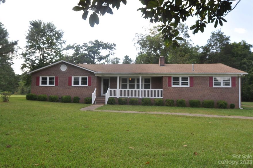 Three bedroom two bath all brick home on 1.867 acres.  Beautiful hardwood floors in the living room and master bedroom.  Enormous kitchen with lots of space. Plenty of wood cabinets and counter top space.  Dining in the kitchen and open to the living room.  Large living room with fireplace.  Master bedroom bath has ceramic tile shower and floors.  Hall bath has ceramic tile flooring and bath surround.  All bedrooms have decent size closet space. Energy efficient windows throughout the home. Covered front porch and enjoy sipping that sweet tea on the screened back porch.  Oversized garage with laundry room and storage room. Come make this one owner family house your home.  Convenient to Rock Hill and Columbia.