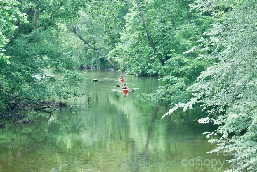 12+ acres with 1,000 ft of river frontage on the Johns River!  The property line follows the centerline of the river.  Build your dream home, small farm, or family compound on your own park-like property. It is partially cleared and mostly flat.  Walk out to the shore with your coffee in the morning or wrap up a kayak trip in your own backyard. Kayak, fishing, pan for gold, or wade and splash on a hot summer day. A gravel driveway is already in place. No minimum square footage or time limit to build within. Lender and builder info available. +/- 1.2 acres of the property is above flood zone, level with River Hollow Trail, and is ideal for a home with a walk out basement. 50 ft NC Stream Buffer and Conservation Easement along bank of river and along the creek that crosses the southwest corner of the lot.  This serene property is located in the South's premier Outdoor Lifestyle Community, The Coves Mountain River Club, a 3,200 acre gated community in the Blue Ridge Mountains of North Carolina. There are miles of community exclusive trails to hike, bike, ride horses, or UTVs. River front picnic pavilions, fire rings, and kayak access points on 5 miles of Johns River, on site.  The crown jewel of The Coves is the magnificent post and beam  clubhouse, Pisgah Lodge, located on one of the highest peaks. There, you'll enjoy a saline pool, fitness center, locker rooms, full kitchen, lending library, pool table, fire pits, wrap around porches, decks, and overlooks to take in 360º views of the Blue Ridge Mountains, South Mountains, and Brushy Mountains. You can see all the way to Mount Mitchell, the highest peak east of the Mississippi.  The Coves is a Dark Sky Community, exterior lighting protocols  minimizes light pollution and provide breathtaking star-gazing. Down by the river you can garden your private plot at the Community Garden or join your neighbors to care for and harvest the community cooperative vineyard. Pickle-ball and shuffleboard courts, putting green, and a picnic pavilion are located at another Coves's park, Wyatt's Landing. There are 2 Coves Equestrian Centers and a thriving equestrian club. (There are 17 private bars too).  There is even a Dog Park!  Join your neighbors for social events, excursions, hiking, travel, yoga. 500,000 acre Pisgah National Forest and the Wilson Creek Wild and Scenic River Area are across the road! 1.25 hour drive to Charlotte or Asheville, minutes to Lenoir, Blowing Rock, Morganton, and the Blue Ridge Parkway.